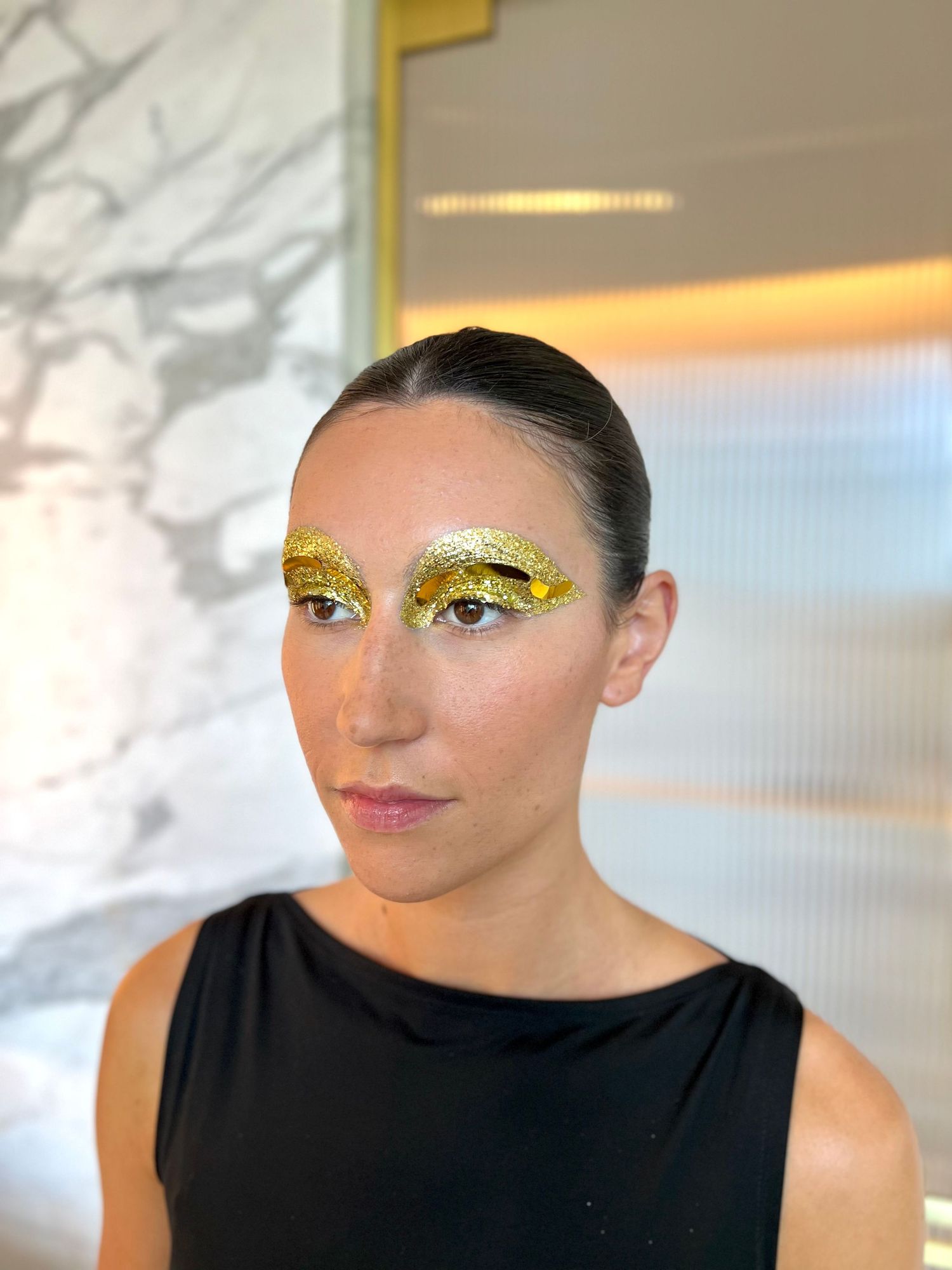 Artistic beauty shots featuring bold gold glitter eye makeup and pink lips.
