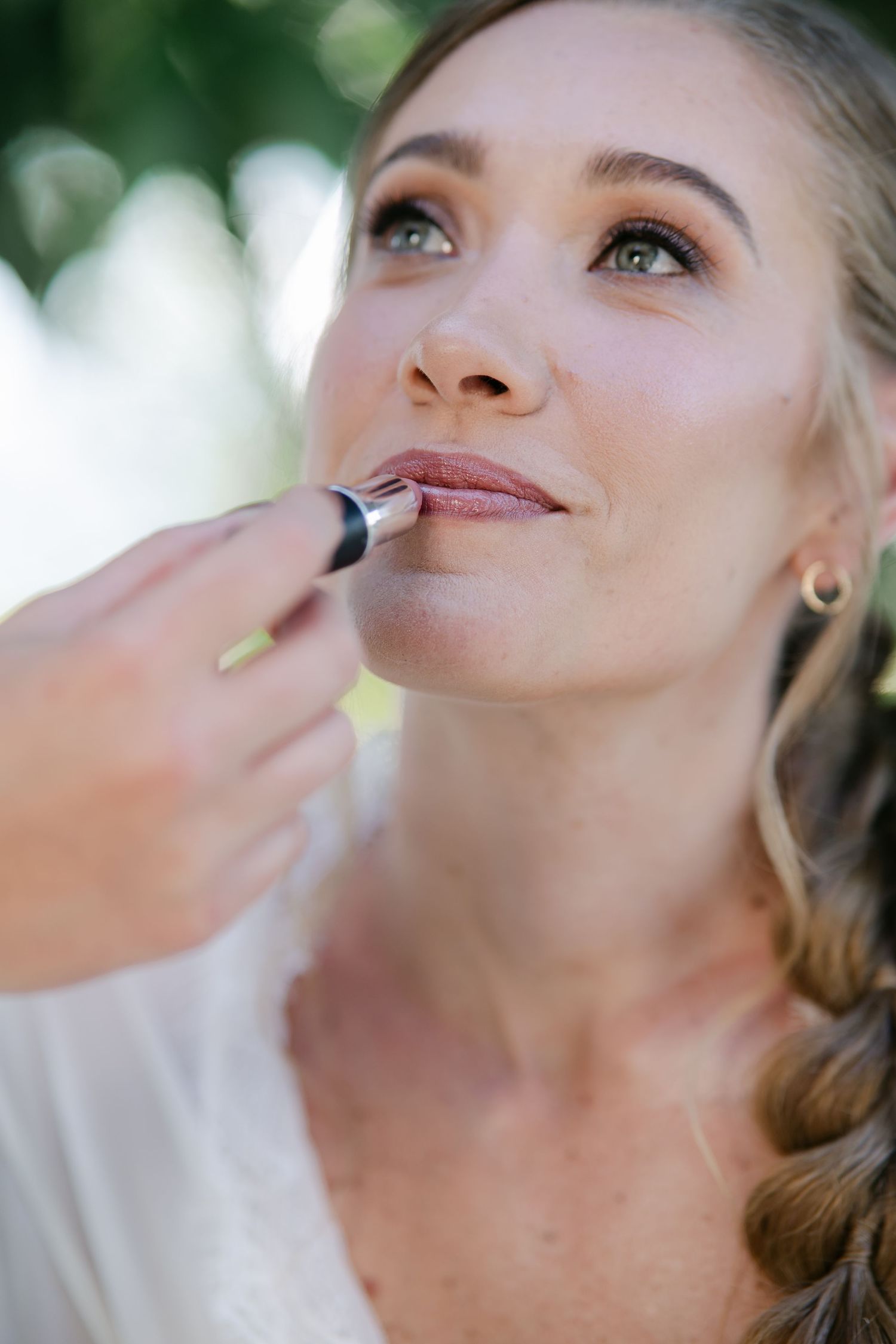 Close-up sequence showing professional makeup application focusing on lip color.