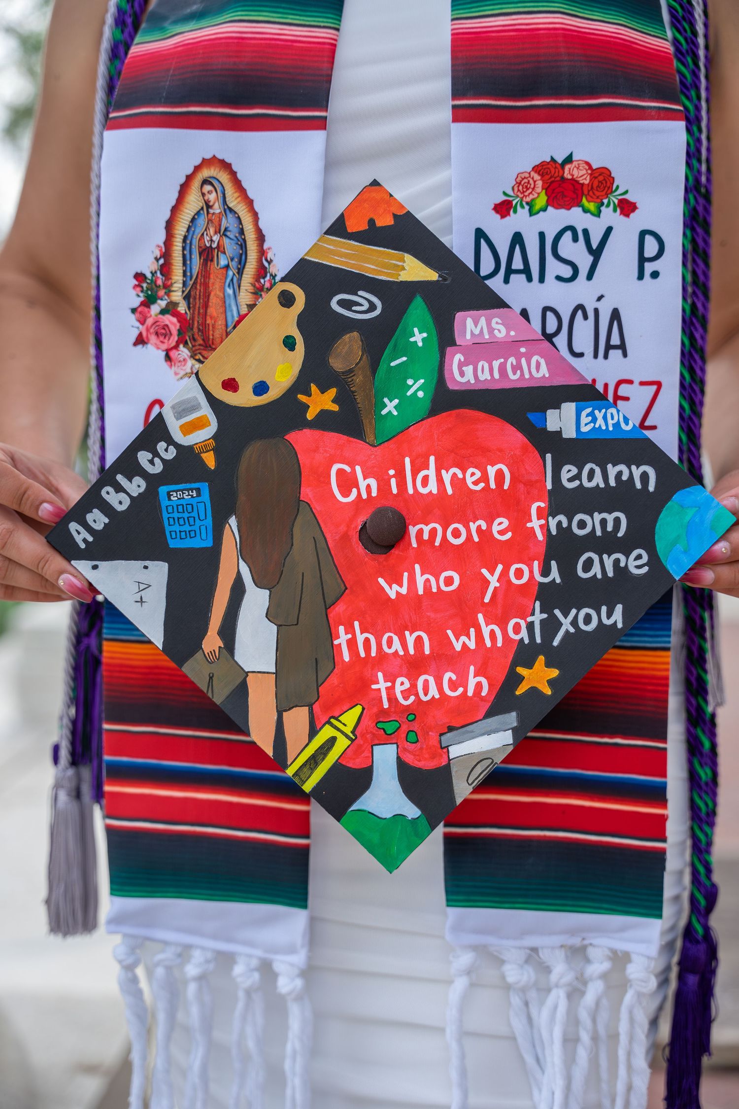 Decorated graduation cap reading Children learn more from who you are than what you teach.
