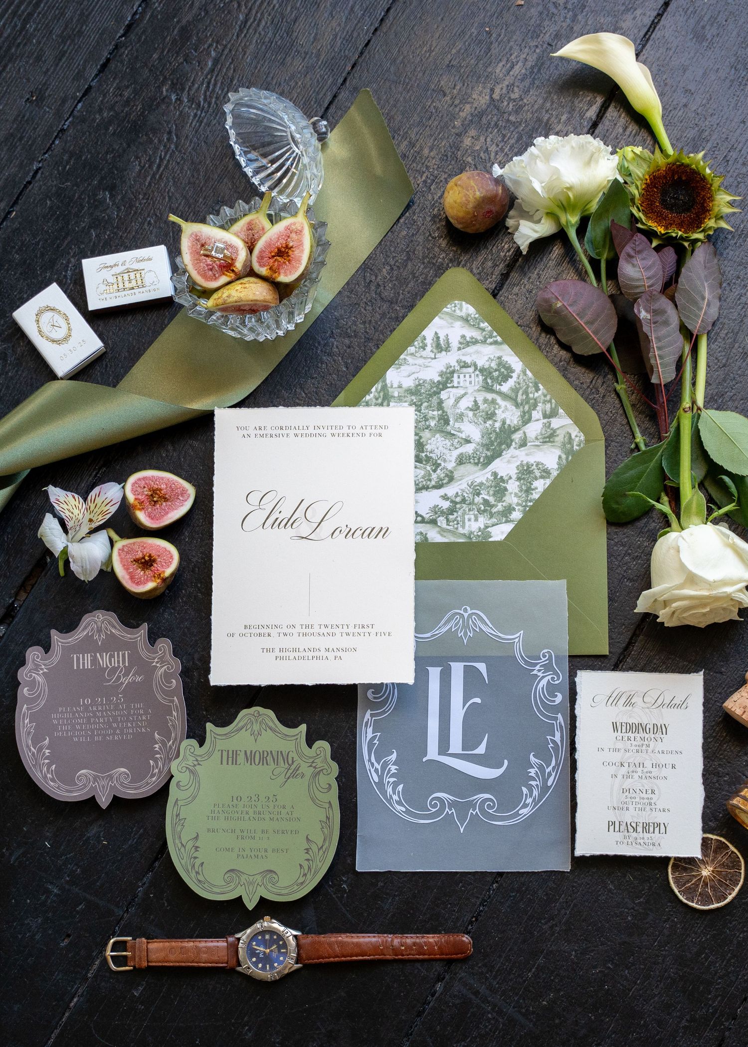 Elegant wedding stationery suite with sage green envelopes, monogram cards, and figs on dark wood.
