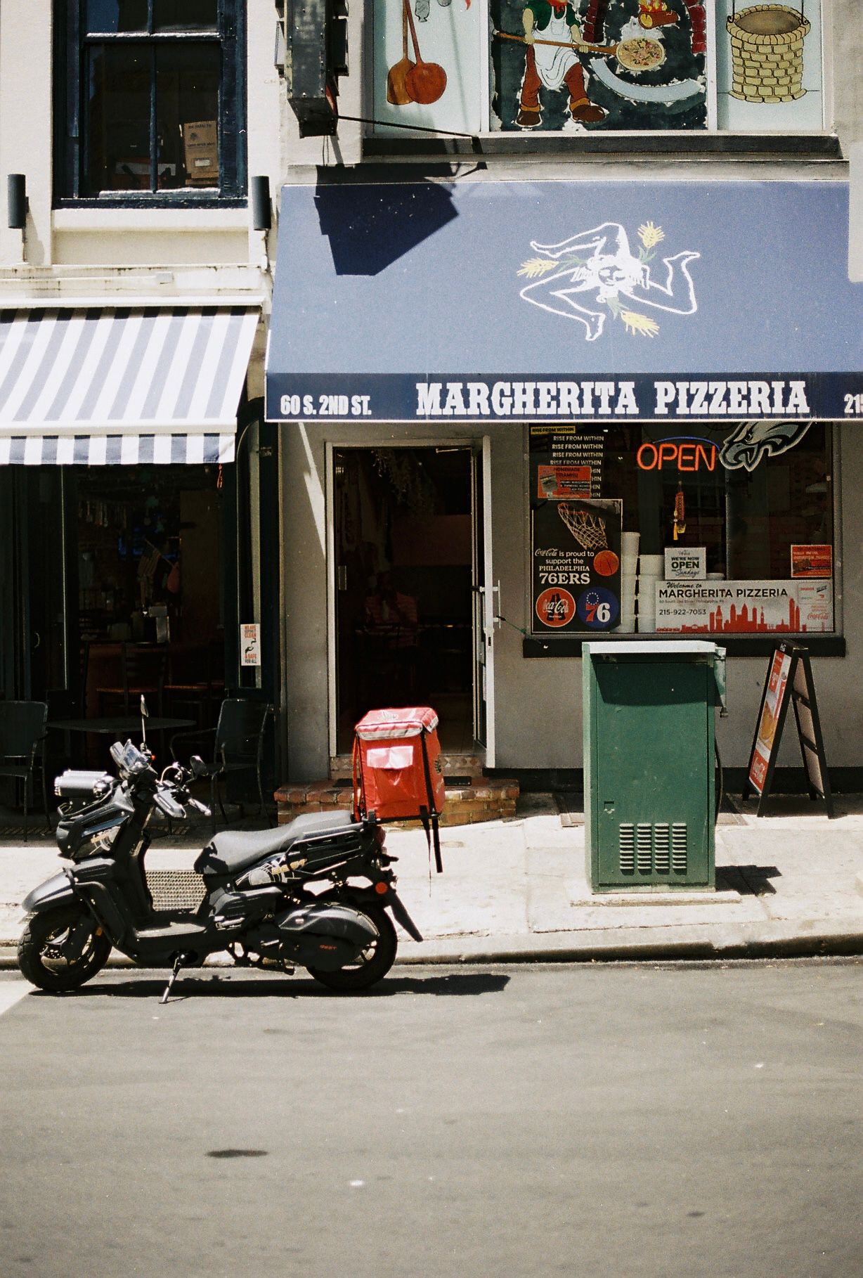 Margherita Pizzeria storefront on S. 2nd St with a scooter parked outside on a sunny day.