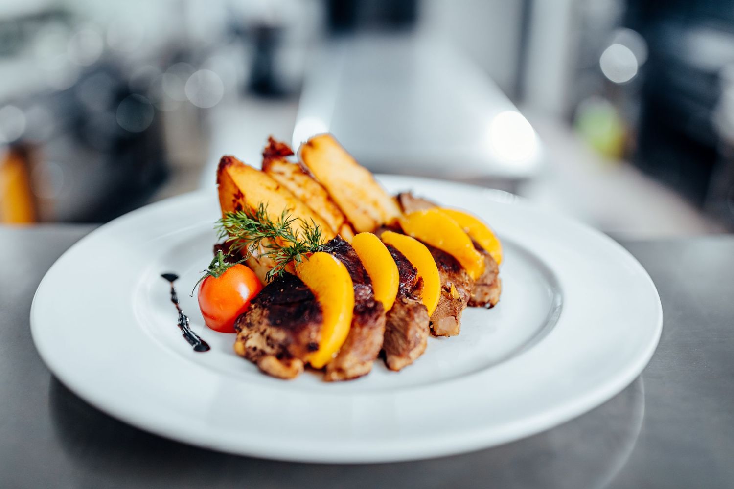 Grilled seafood and vegetables plated elegantly on white dishes.