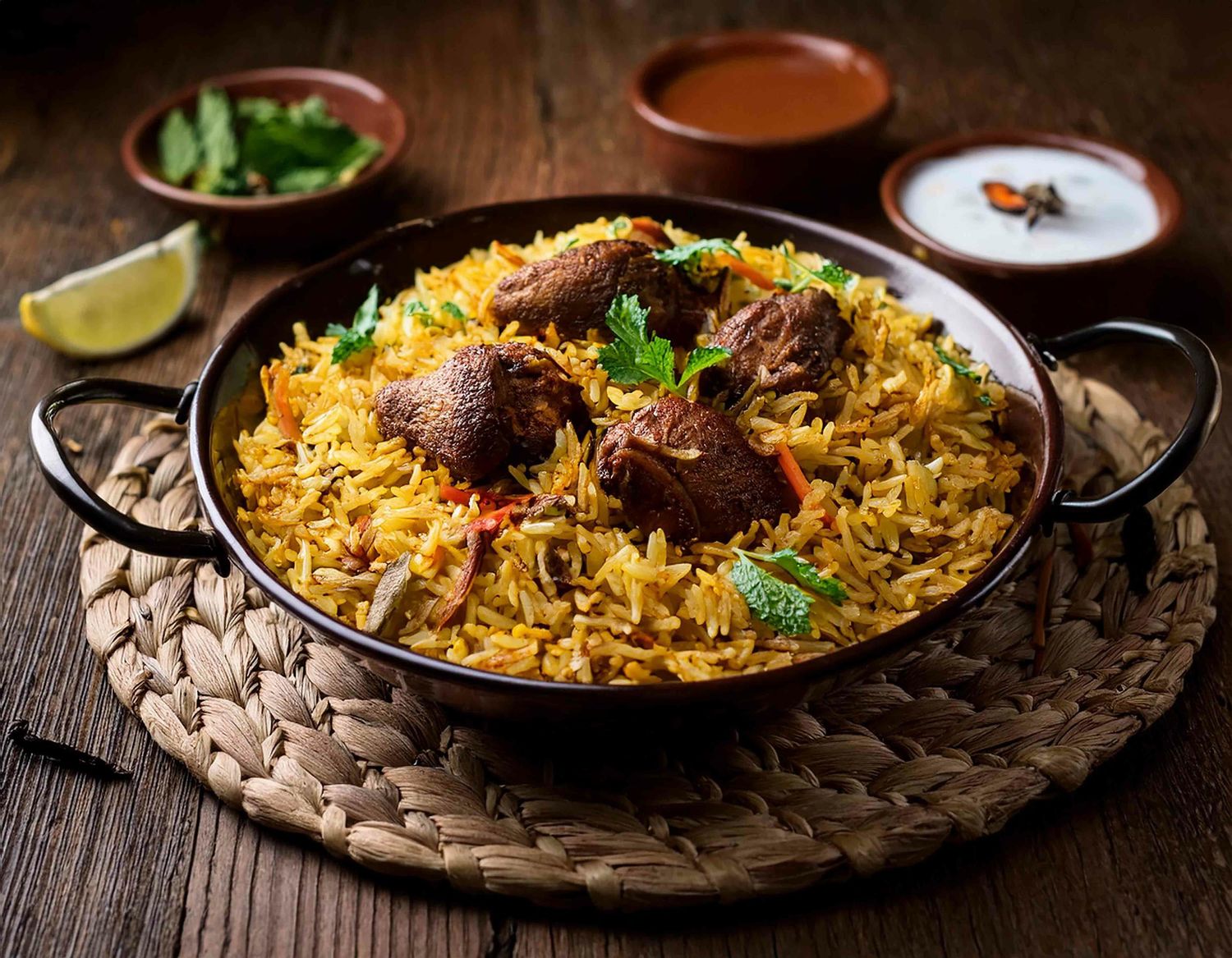 Aromatic biryani rice dishes garnished with herbs and served in traditional style.