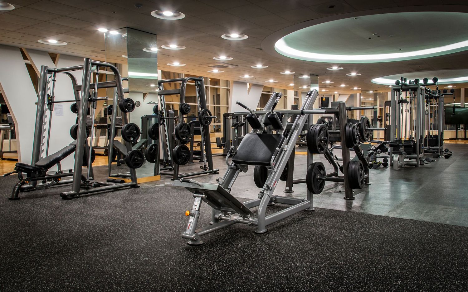 Large well-equipped fitness center with various exercise machines and equipment.