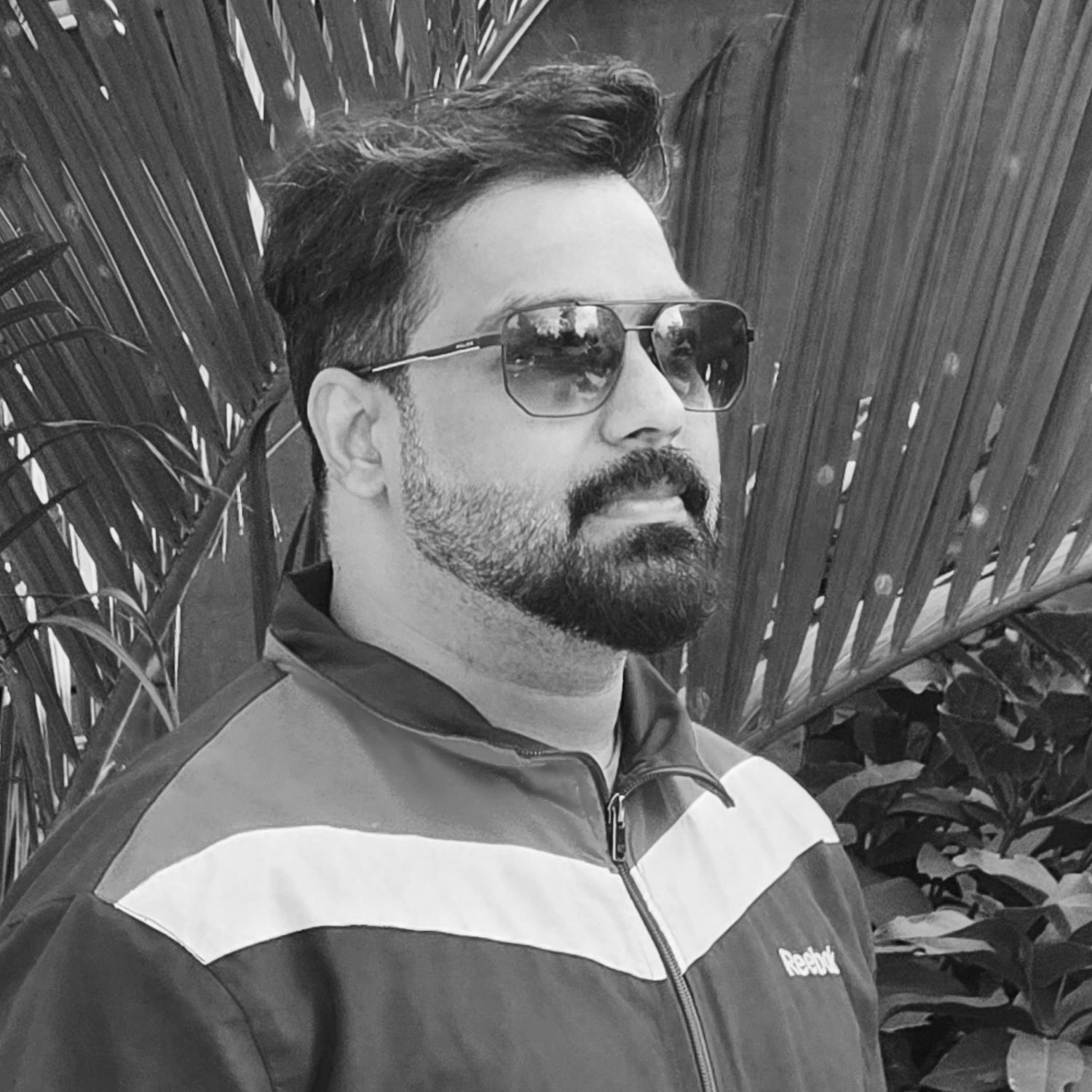 Black and white portrait series showing different angles in sunglasses outdoors.