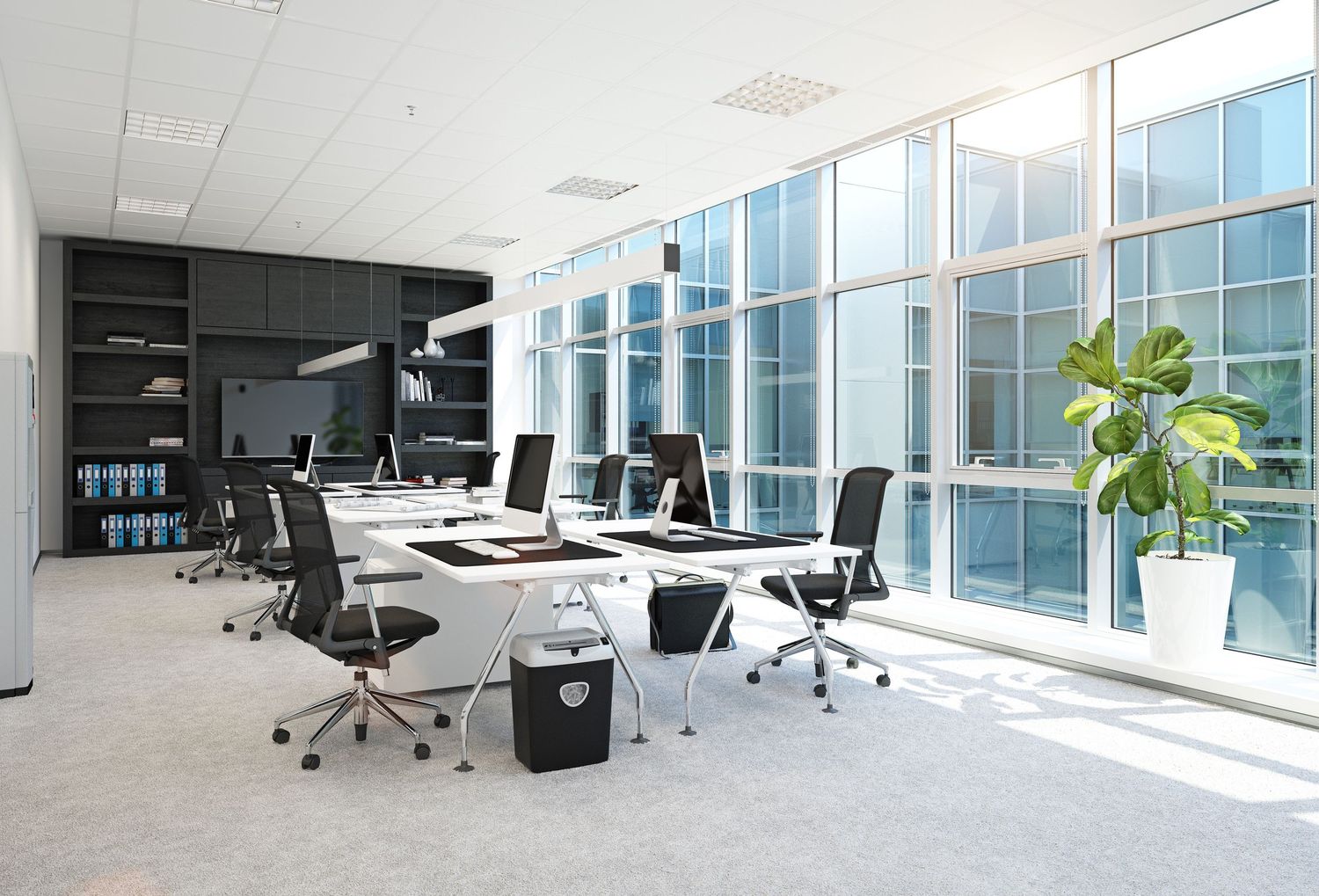 Modern open office space with floor-to-ceiling windows, ergonomic chairs and minimalist desks.