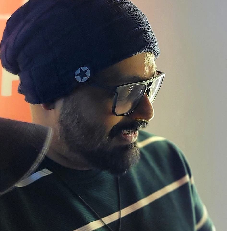 Close-up shots of someone wearing glasses and a beanie hat in moody lighting.