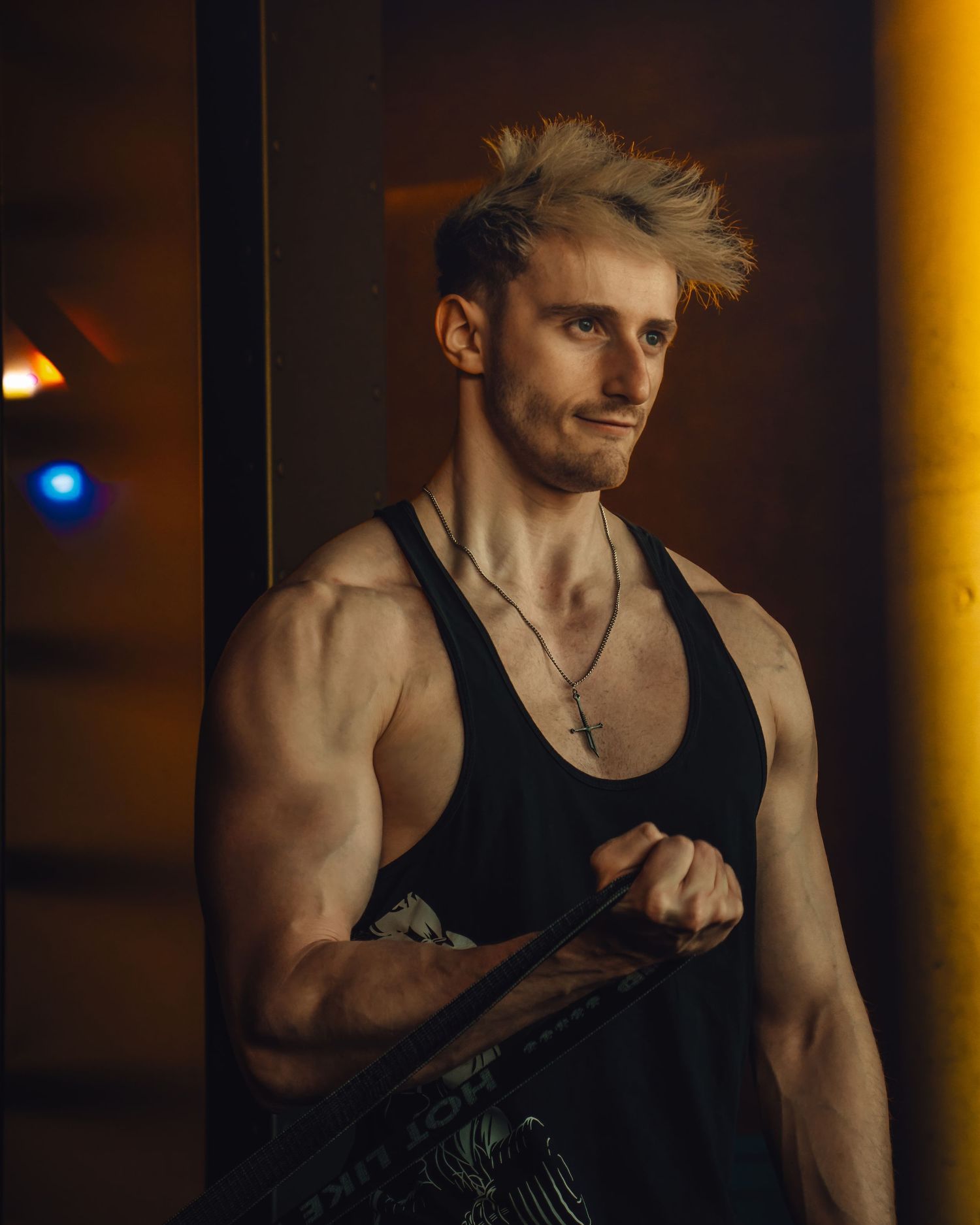 Athletic figure in dark tank top shown working out in dramatic low-light conditions in multiple poses.