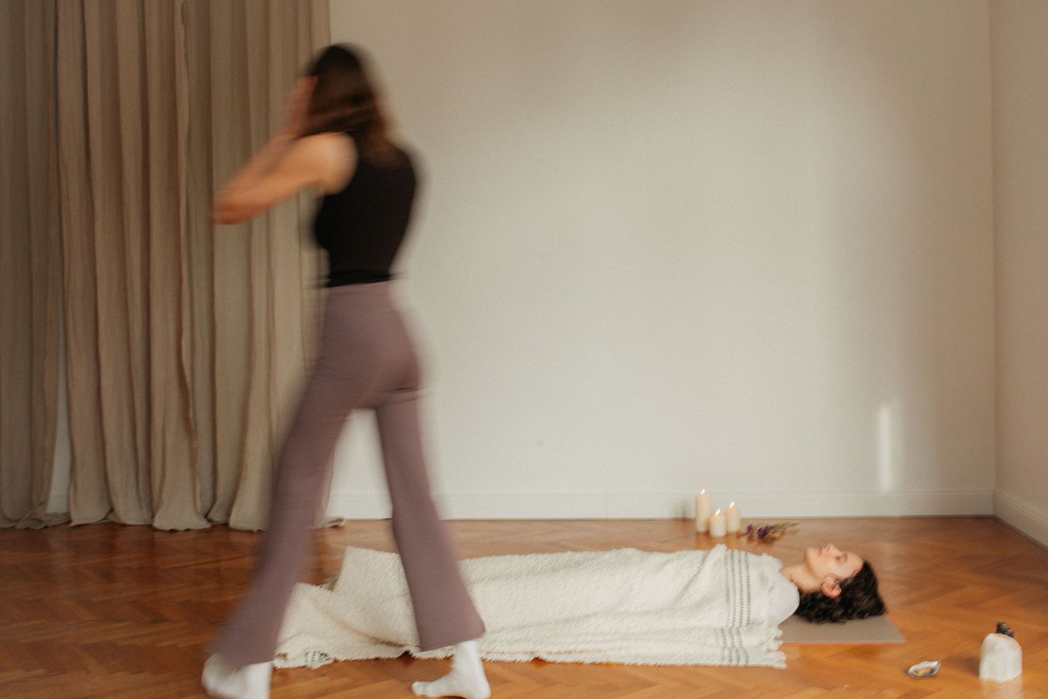 A sequence of dance movement photos showing a person in motion against a white studio wall and floor.