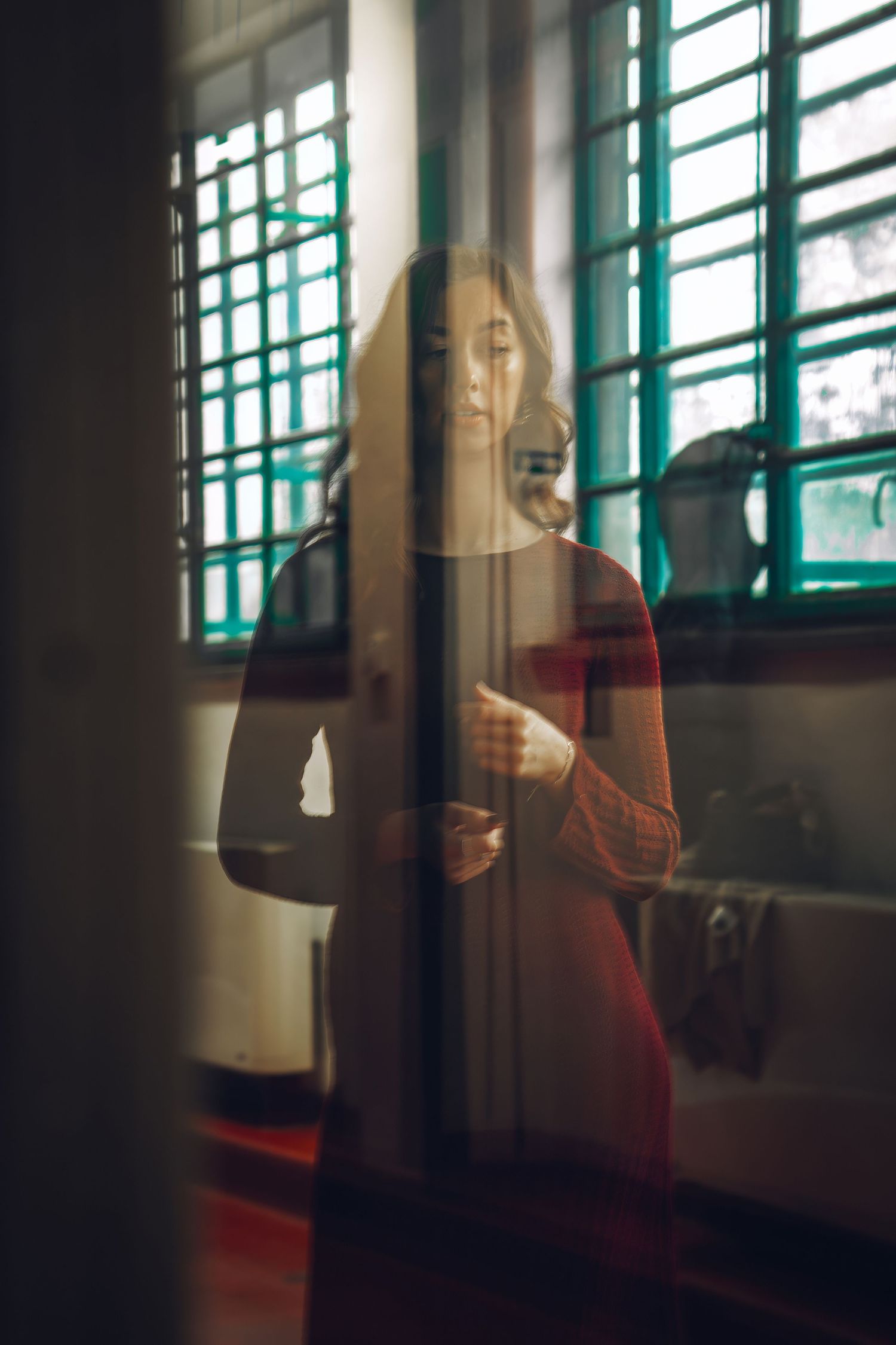 A sequence of images showing a person in red against a window with prison-like bars creating a moody atmosphere.