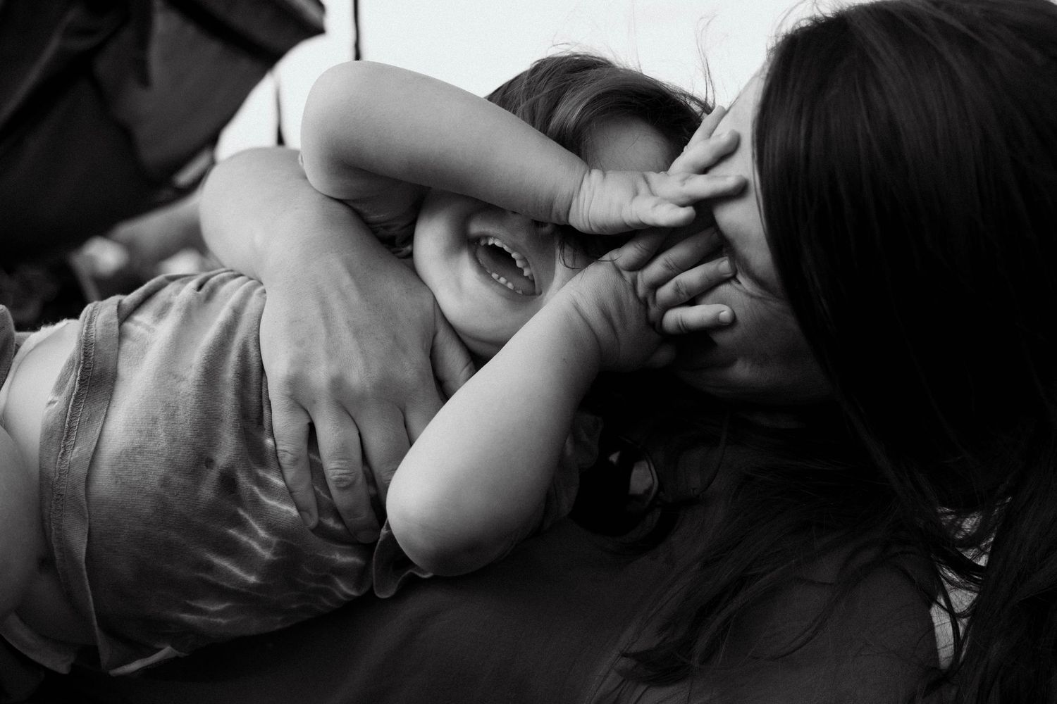 Four black and white photos showing intimate moments between a couple in romantic poses.