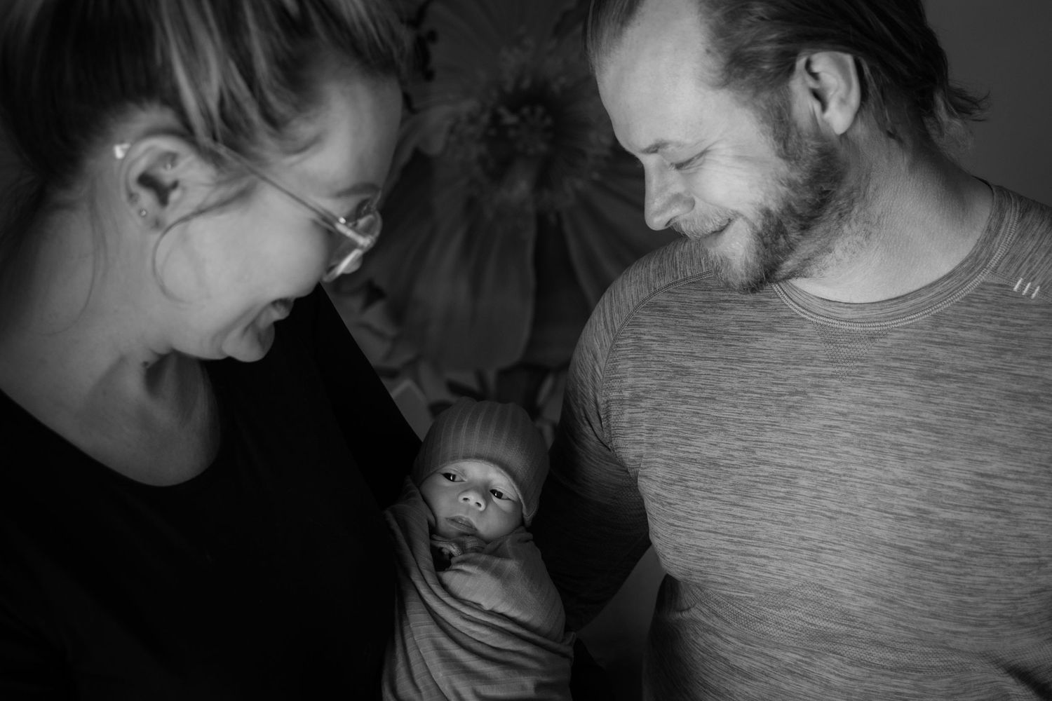 Newborn photography session in Crested Butte, Colorado of parents with newborn baby black and white photo.