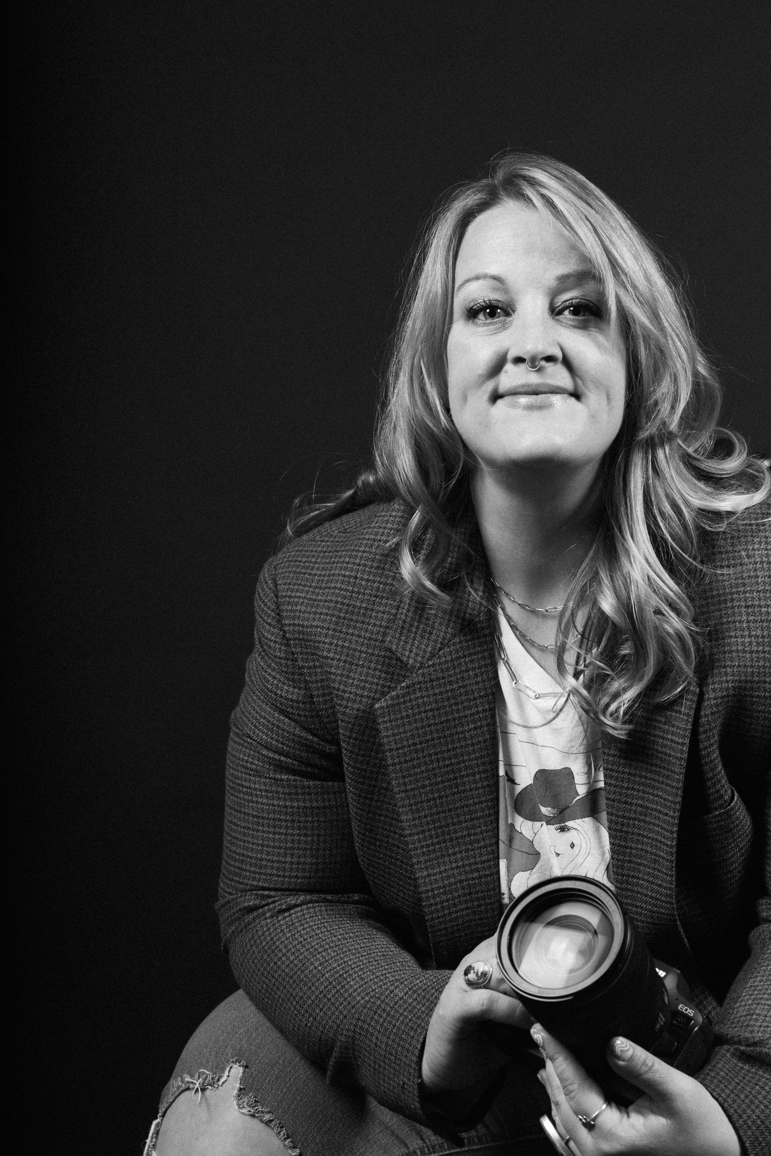 A black and white photo sequence showing a person in a blazer jacket smiling and posing with a camera.