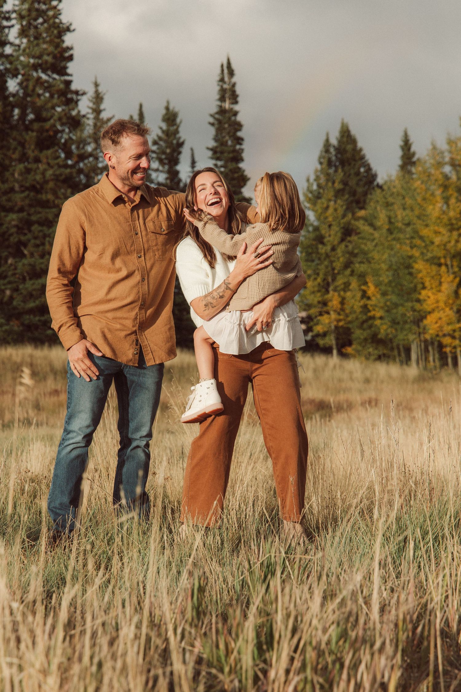 Fall family photo Crested Butte, CO with golden aspens and mountain views ski lifts