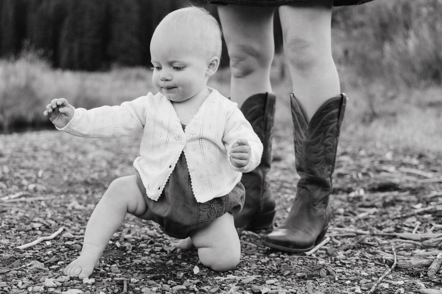 A sequence of candid moments showing a toddler learning to walk on a natural path.