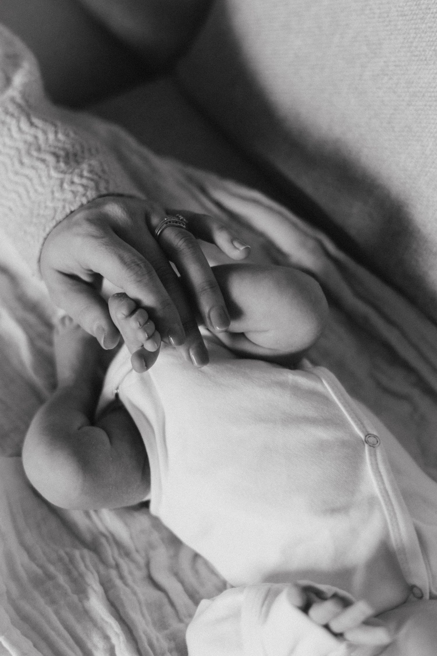 A series of black and white photographs showing hands tenderly touching and interacting in an artistic composition.