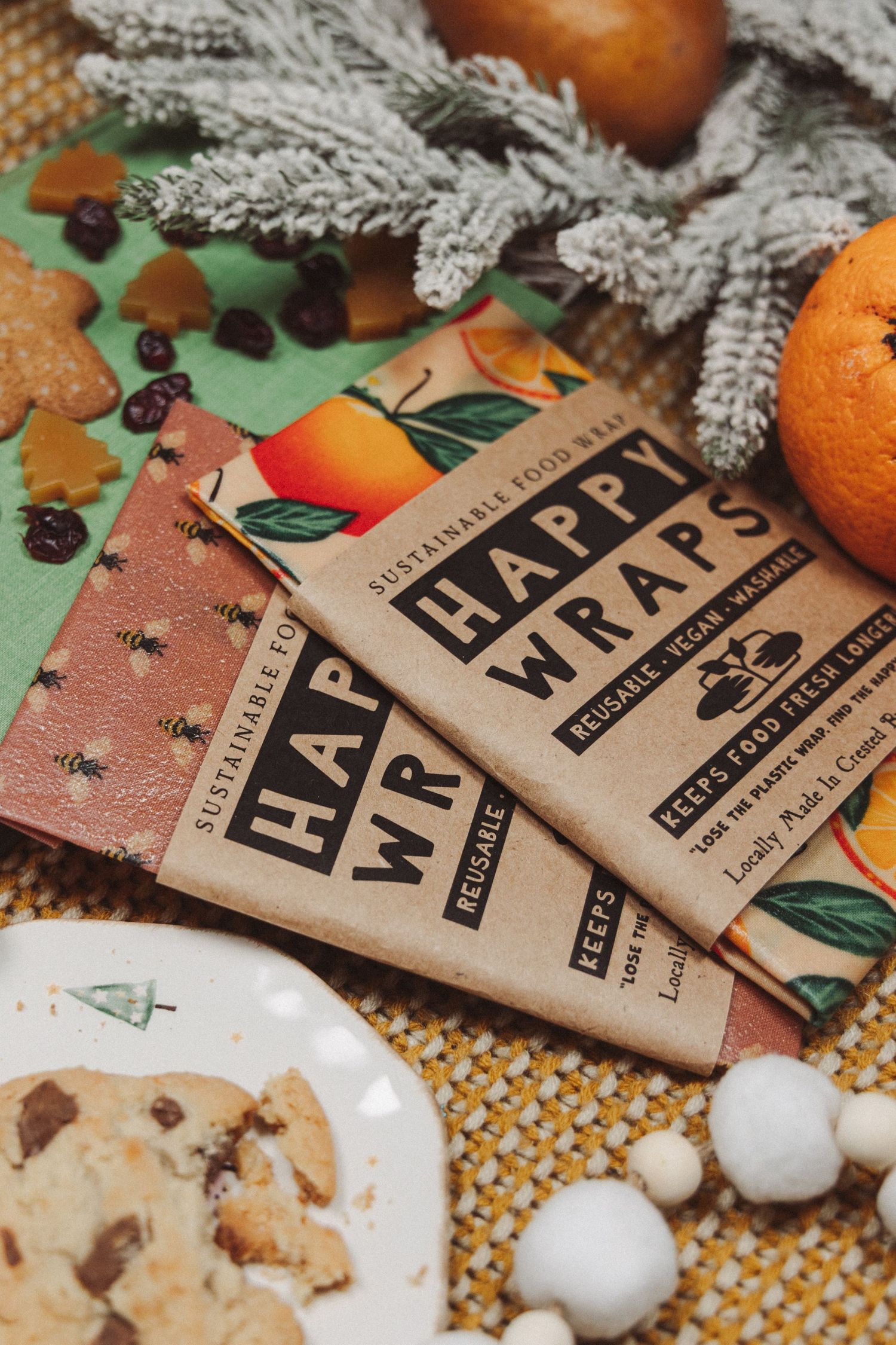 Chocolate bars and holiday decorations arranged with oranges and silver tinsel against a festive background.