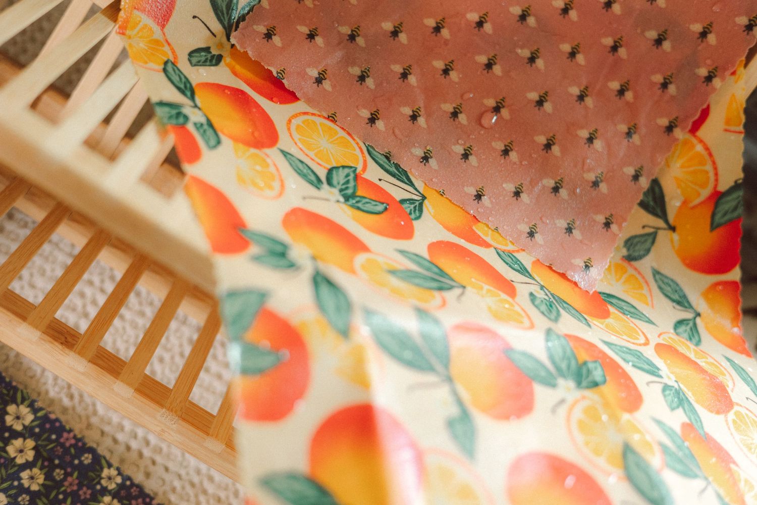 Colorful floral pattern wallpaper with orange and green motifs against a white background.