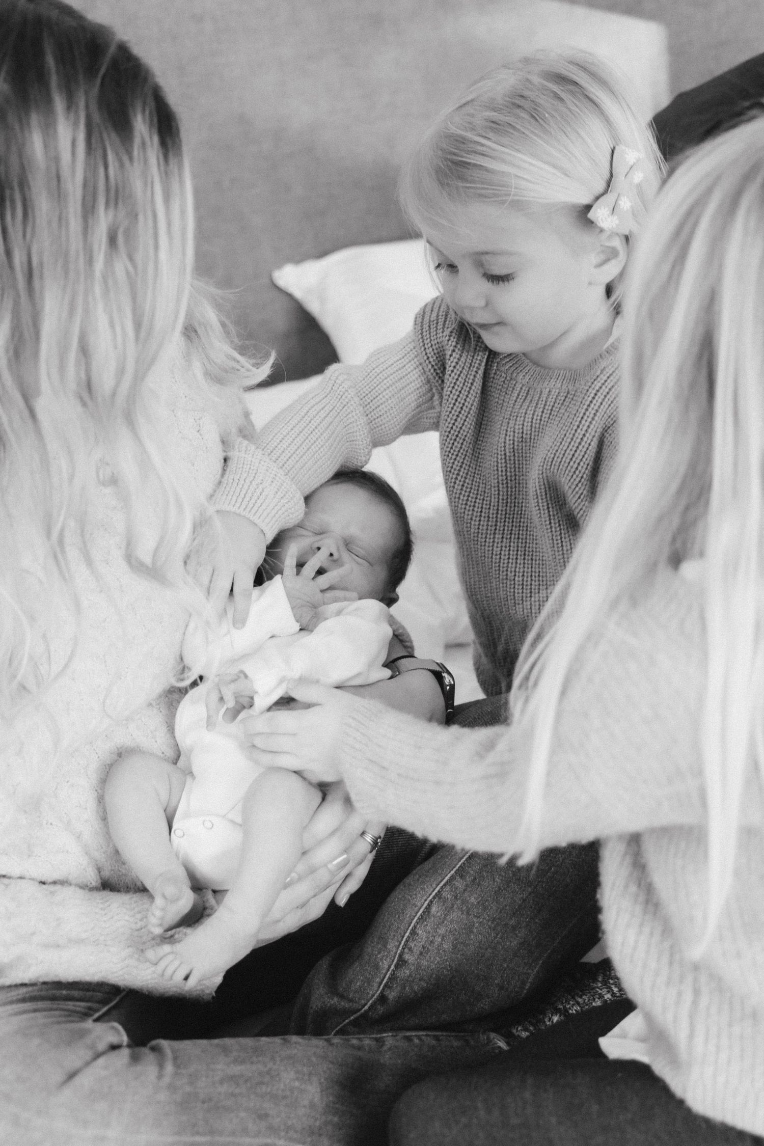 At home newborn photography on bed. Crested Butte, Colorado sisters