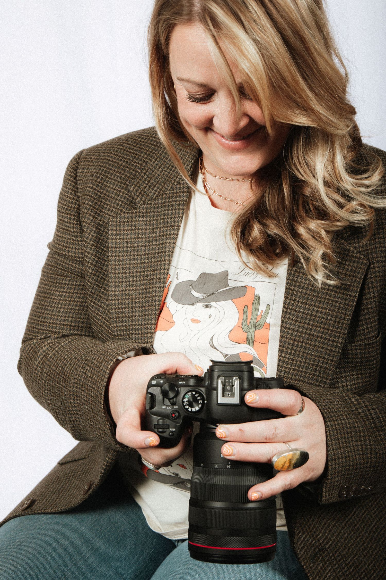 A sequence of photos showing someone in a brown blazer examining a camera lens with playful curiosity. Crested Butte