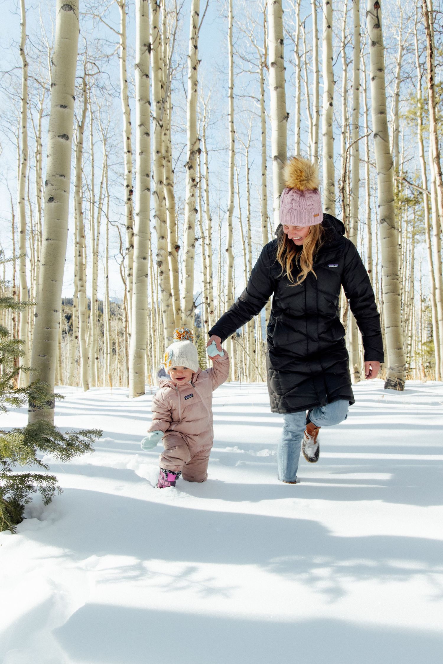 A sequence of winter photos shows someone playing and walking through a snowy aspen forest grove.