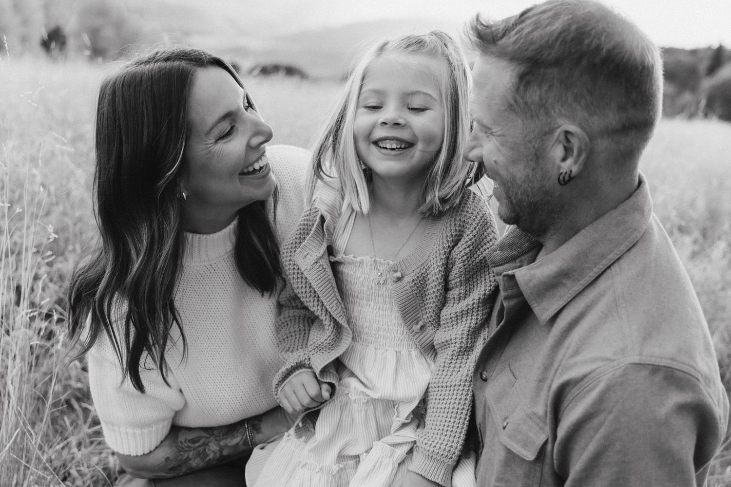 Black and white candid family portraits showing intimate moments and laughter.