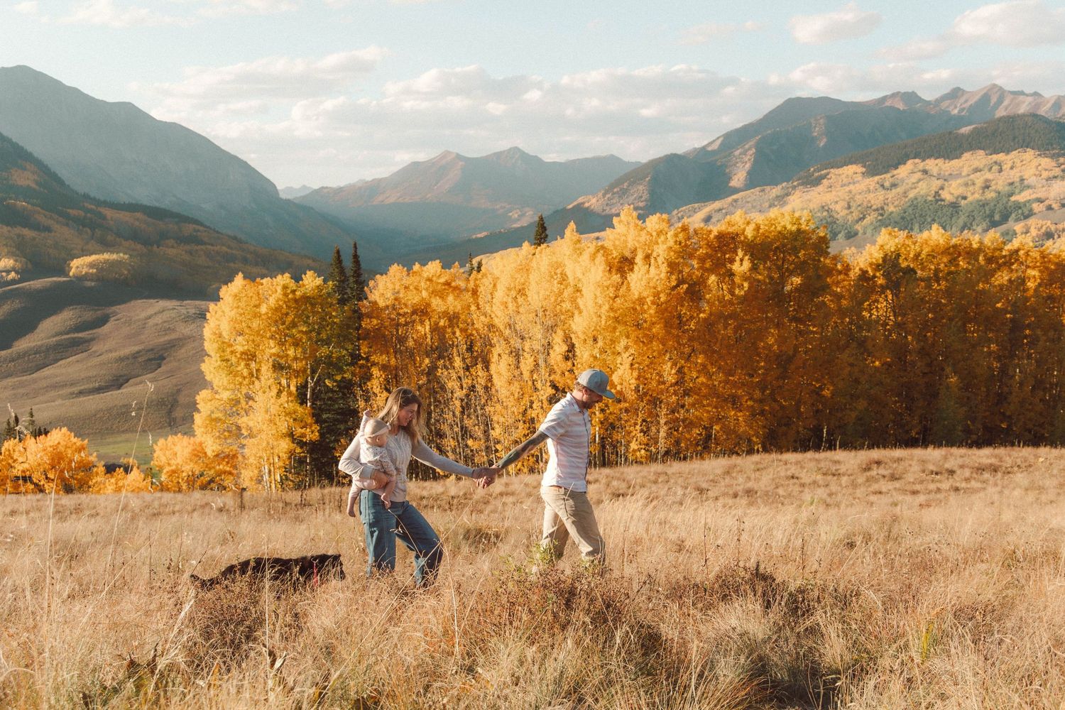 Fall family photo Crested Butte, CO with golden aspens and mountain views ski lifts