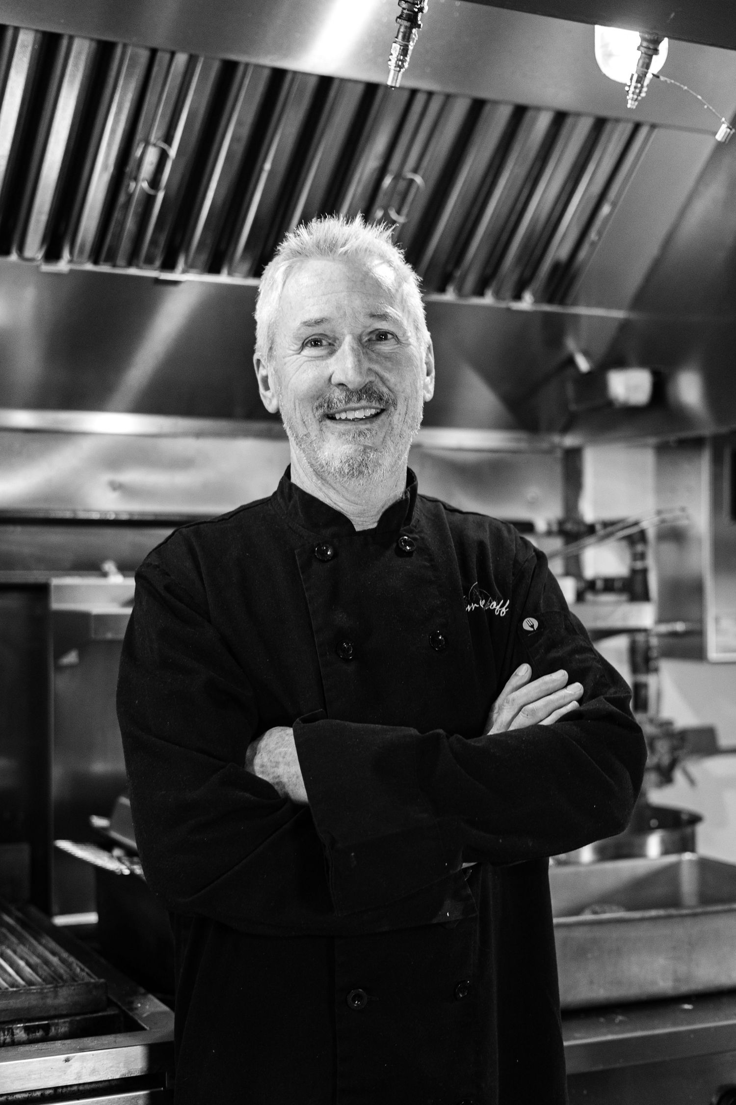 Portrait photography session in Crested Butte, Colorado in chefs jacket in kitchen.