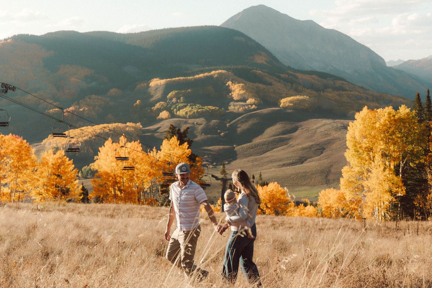 Fall family photo Crested Butte, CO with golden aspens and mountain views ski lifts