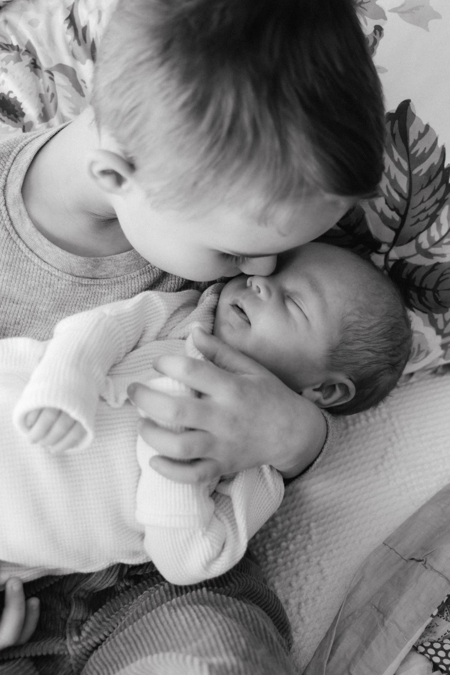A series of black and white photos showing a sleeping baby in various peaceful poses.