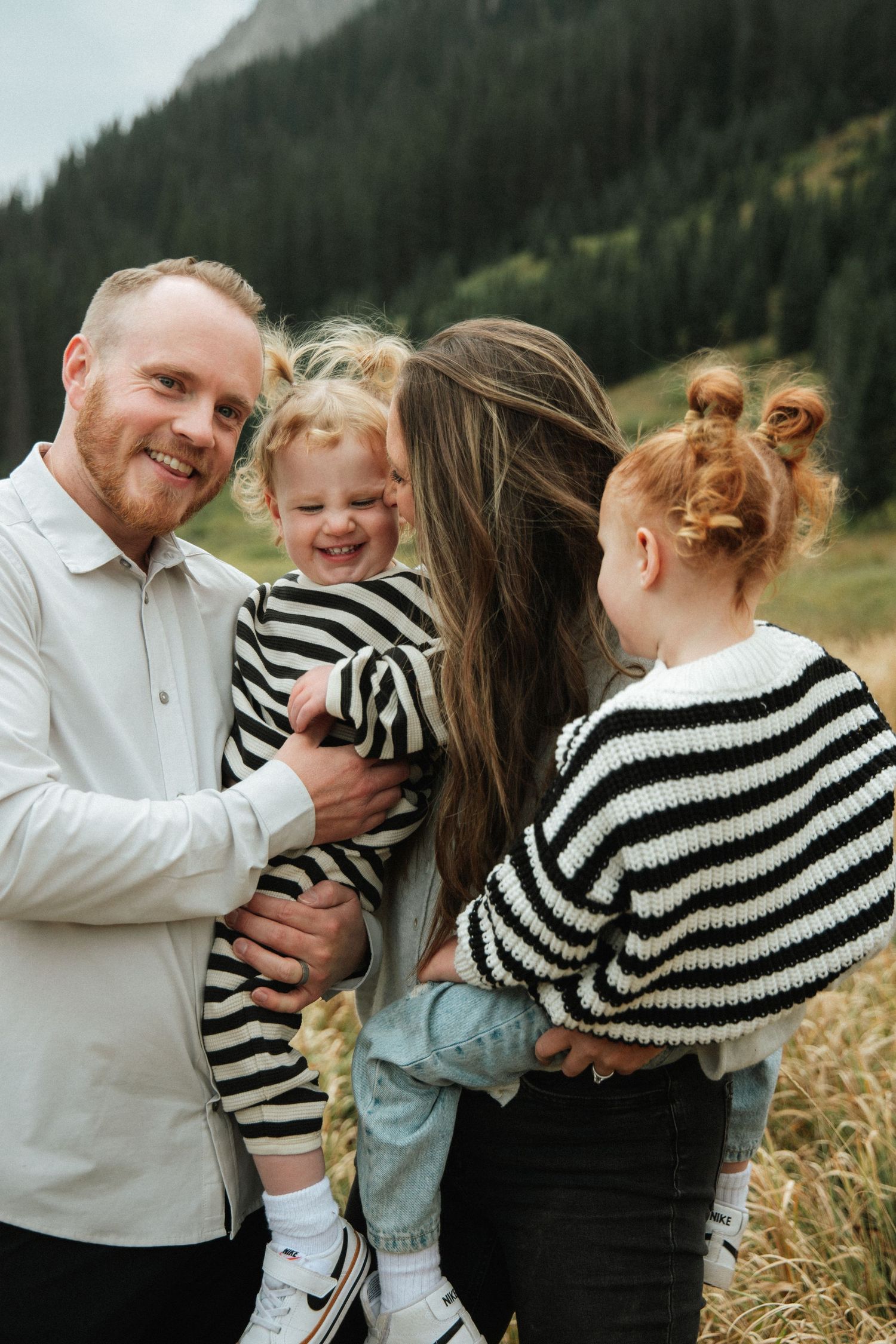 Candid family moments captured against a mountainous backdrop during golden hour.