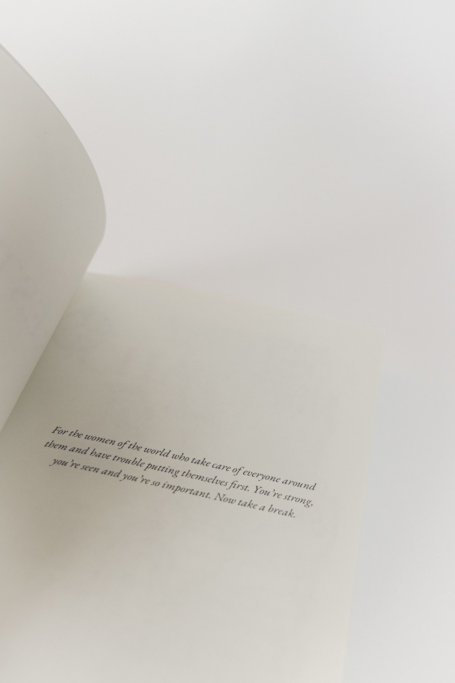 Close-up view of faded text printed on white paper with soft lighting and blurred edges.