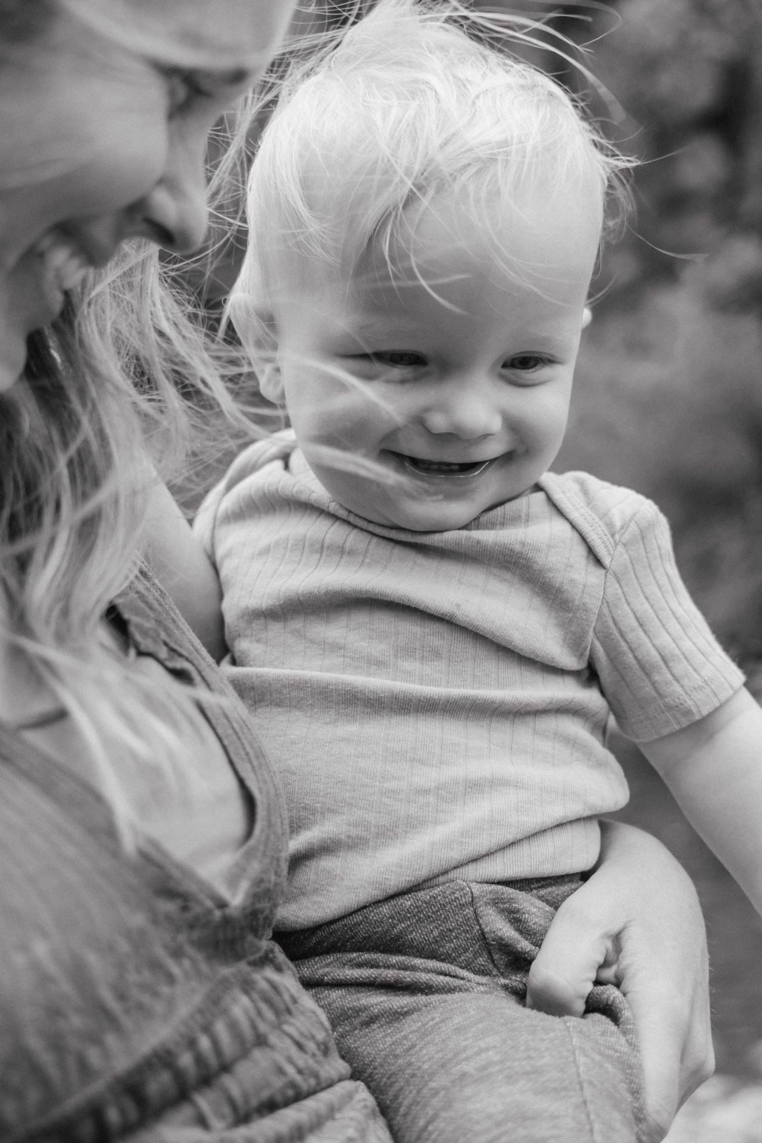 A joyful black and white portrait capturing a tender moment of connection and laughter.
