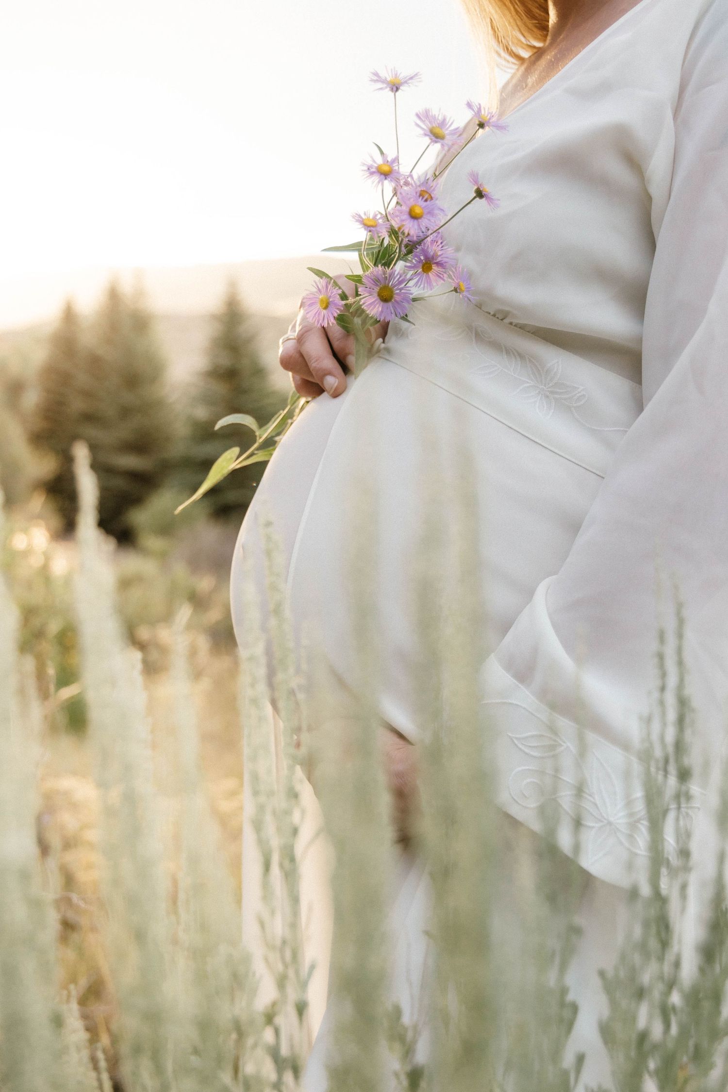 Maternity photography session in Crested Butte, Colorado in sagebrush with flowers.