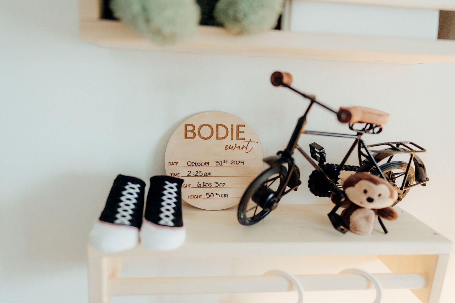 Close-up of wooden shelf displaying baby toys and decorative elements.