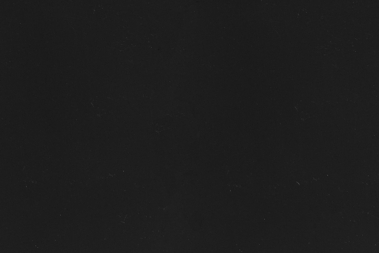 A black and white photograph shows a row of five identical dark rectangles against a dark background.