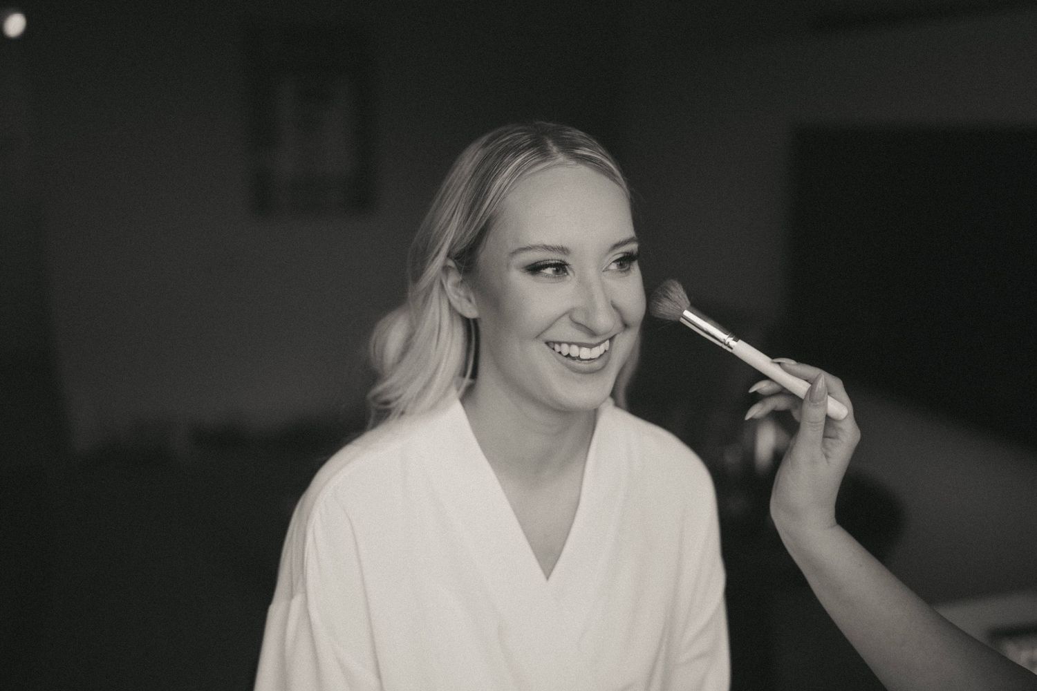 Close-up beauty shot of bridal makeup application in monochrome.