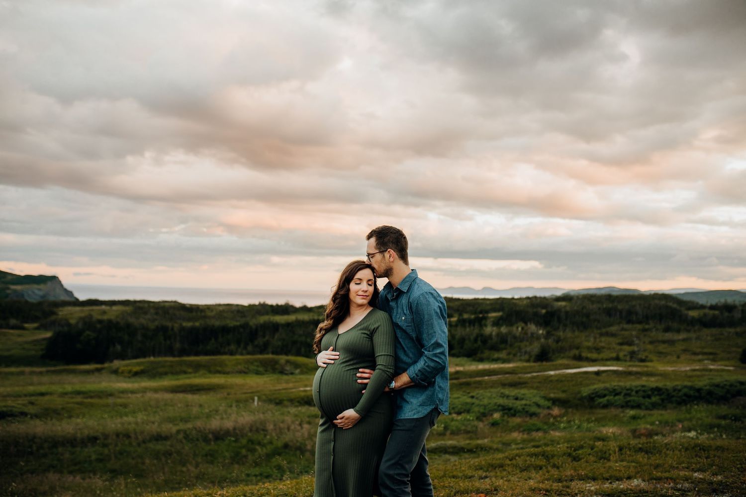 Intimate couple's portrait session in rolling green hills during sunset.