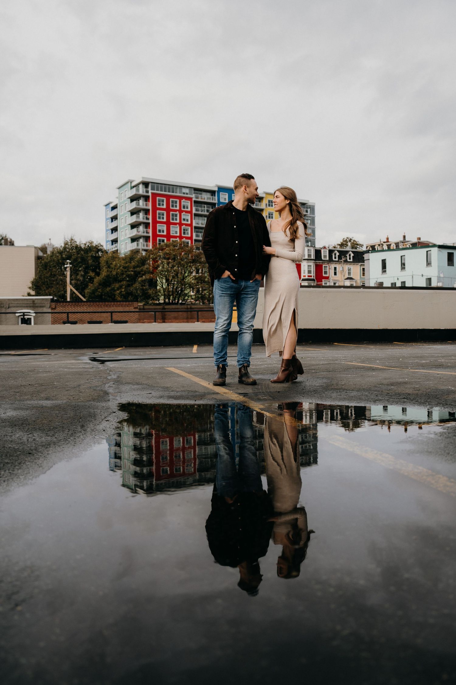 A romantic urban rooftop photoshoot with a perfect reflection in standing water.