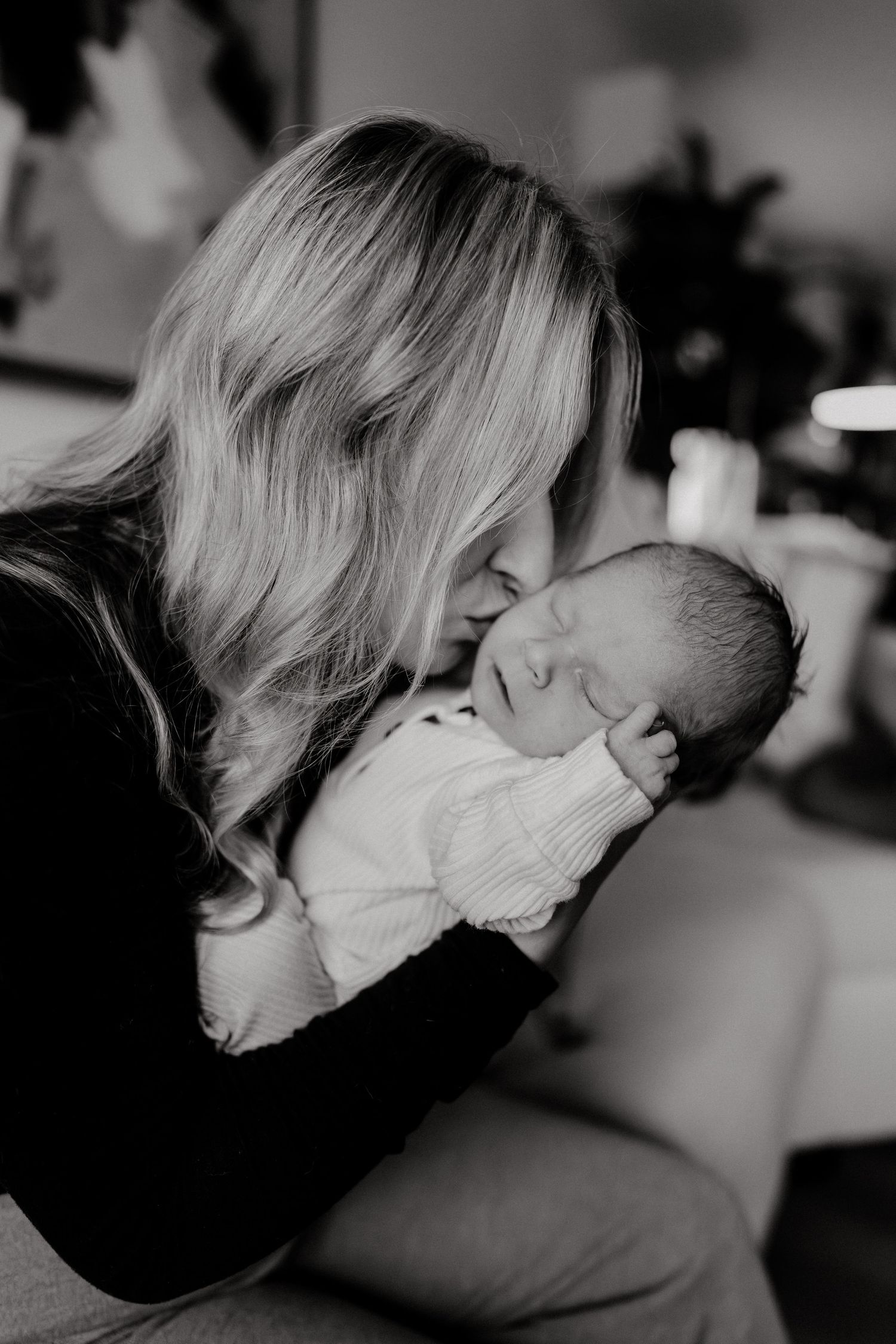 Artistic black and white photograph showing loving connection with a newborn.