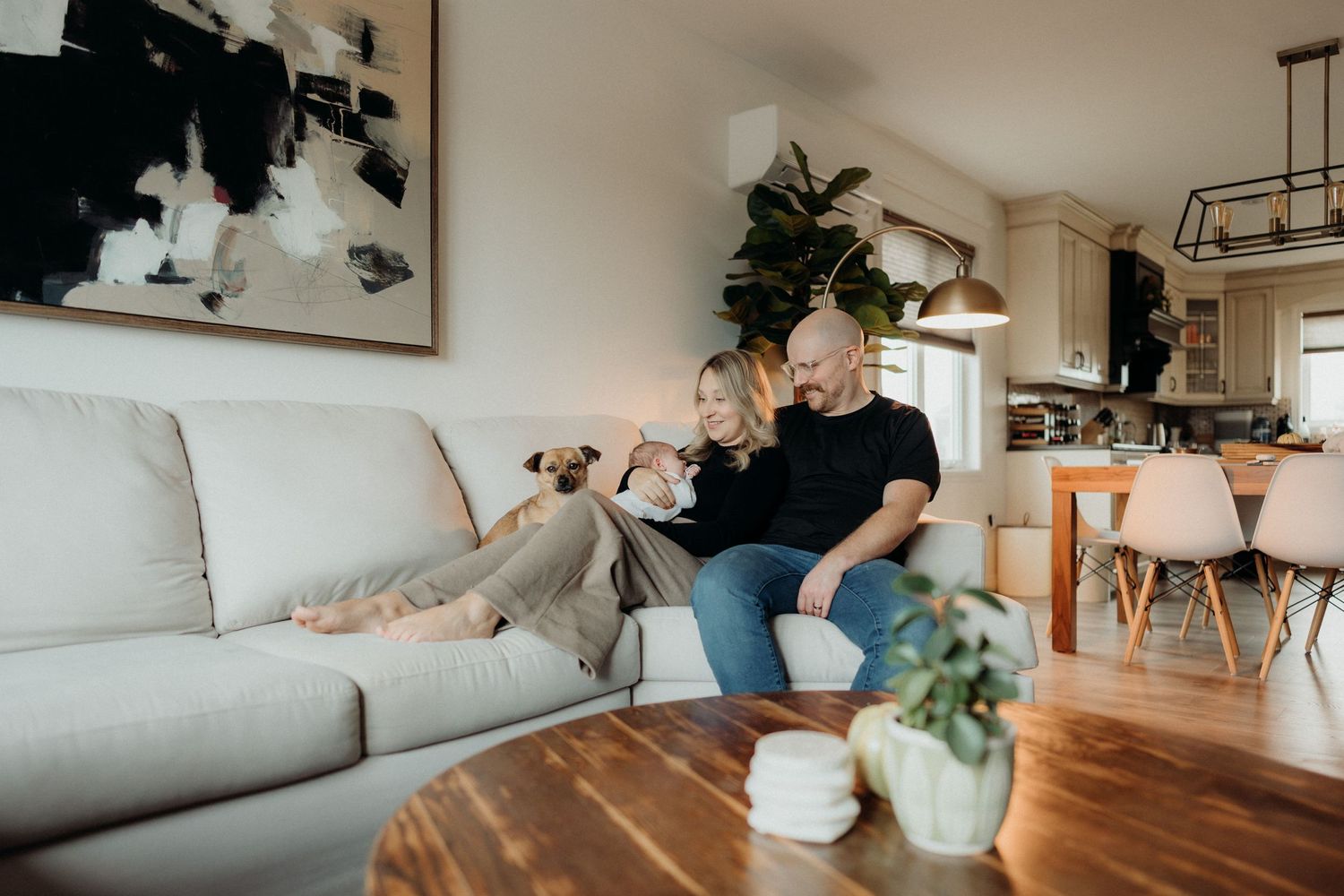 Wide interior shots of modern living room featuring family moments on gray sectional.