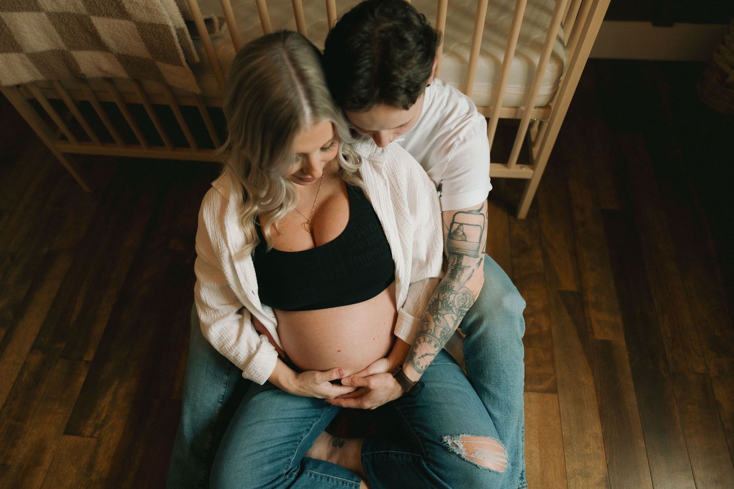A series of intimate maternity photos showing a pregnant belly in various poses against a warm wooden floor backdrop.