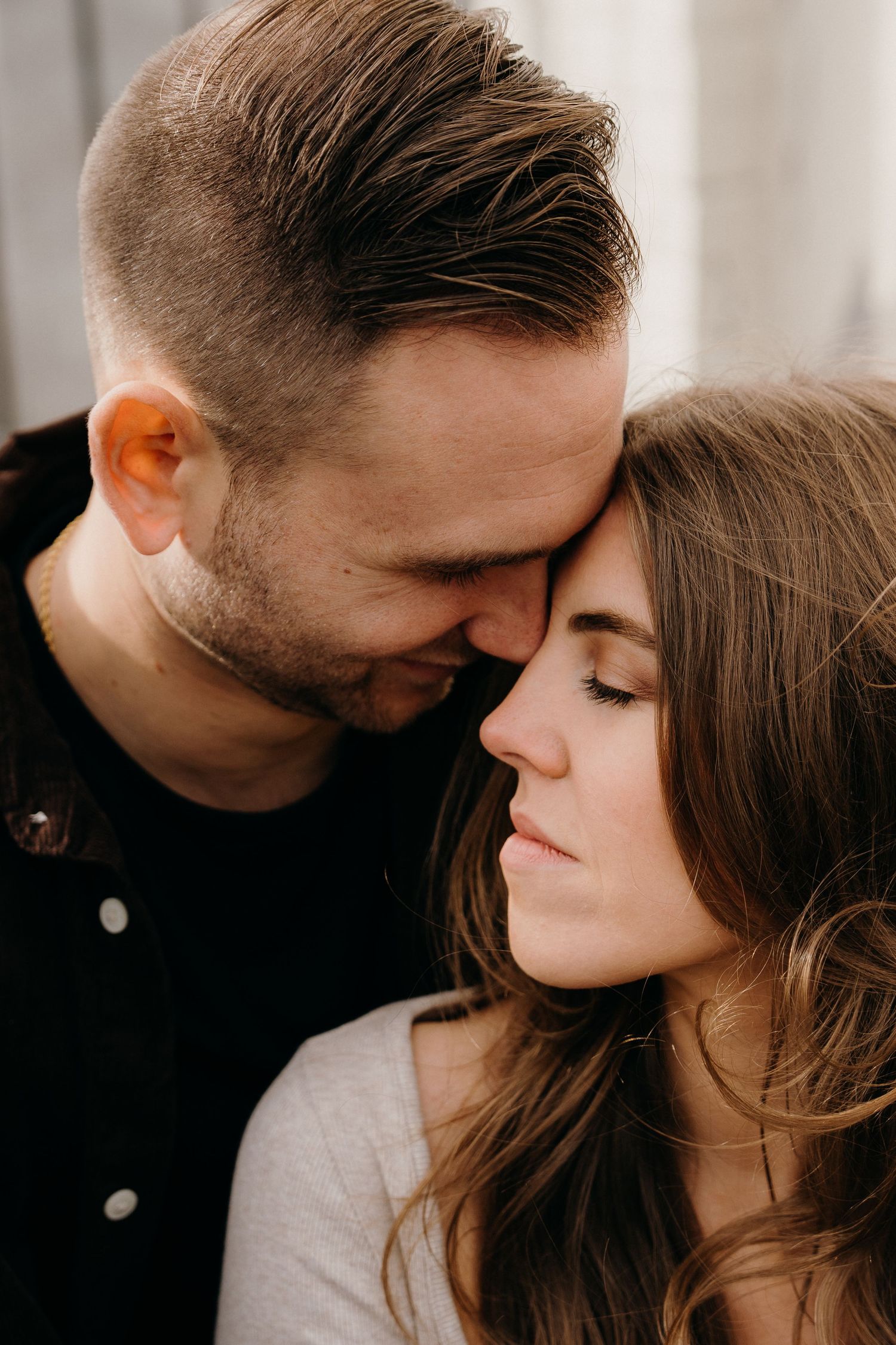 Romantic couple sharing intimate close-up moments with soft lighting.