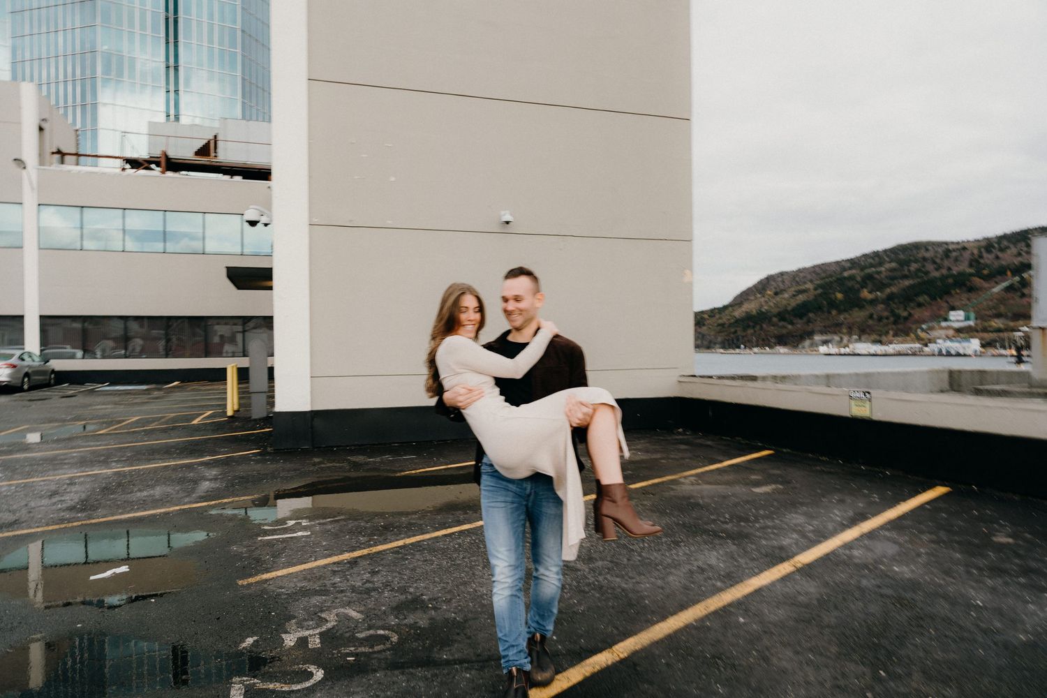 Candid engagement photography captured on a modern urban rooftop.