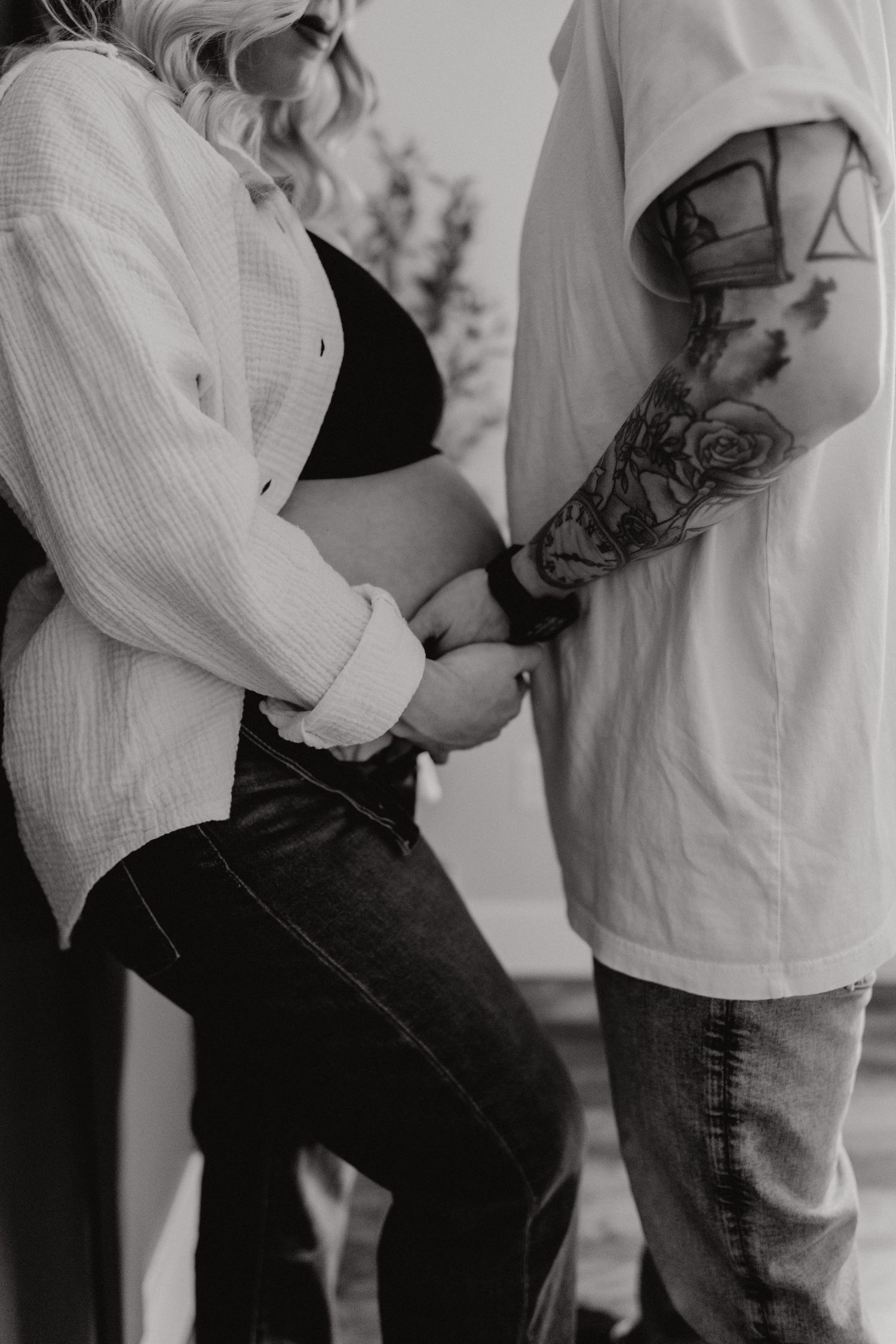 Couple embracing in casual white and dark clothing shown in intimate black and white photo sequence.