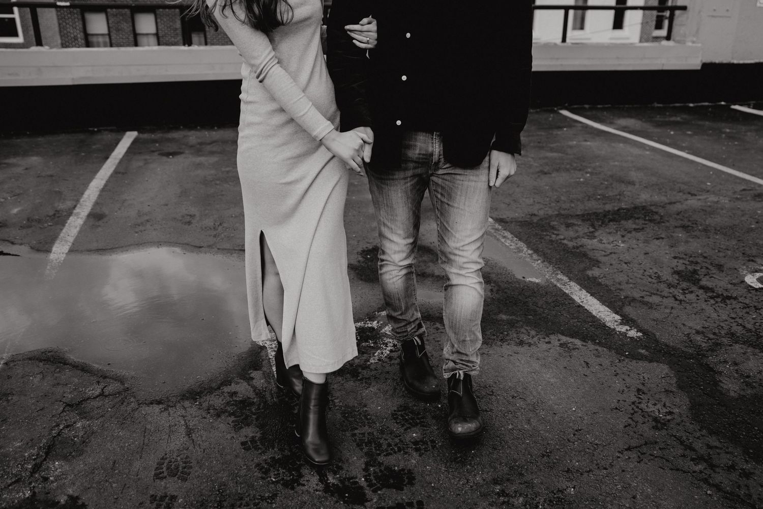 Urban rooftop photography session showing romantic couple interaction with city backdrop.