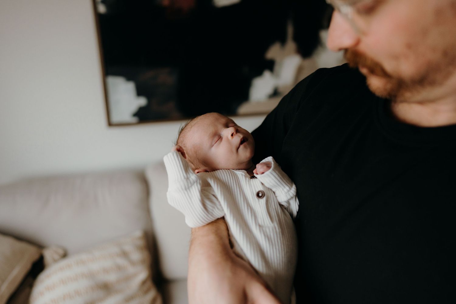 Candid family lifestyle photos showing gentle interactions in natural indoor lighting.