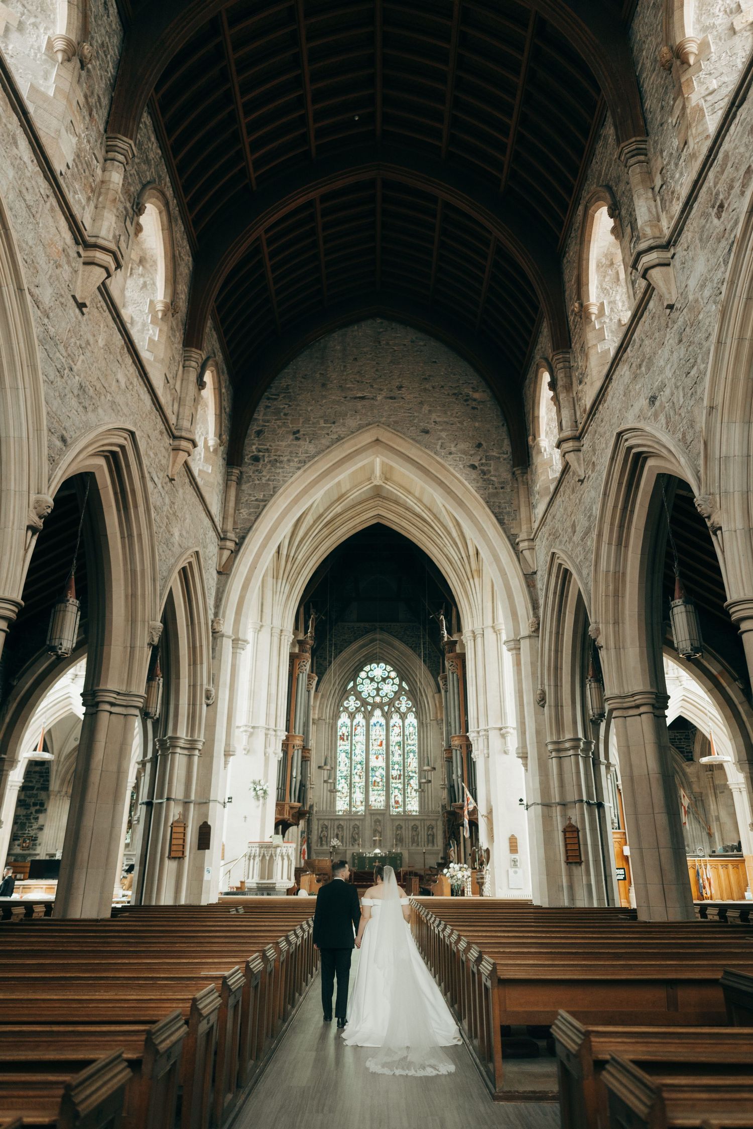 Wide angle shot of a historic church's dramatic vaulted ceiling and Gothic architectural details.
