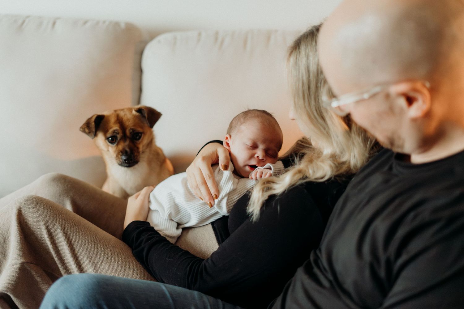 Intimate monochrome capture of a family scene on a couch.