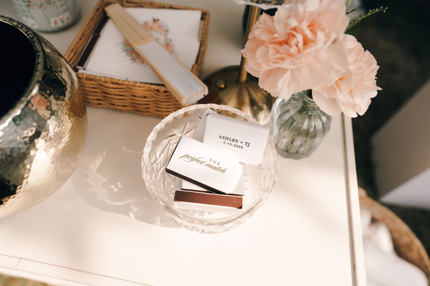 Soft focus tabletop styling with peach flowers and delicate decor items.